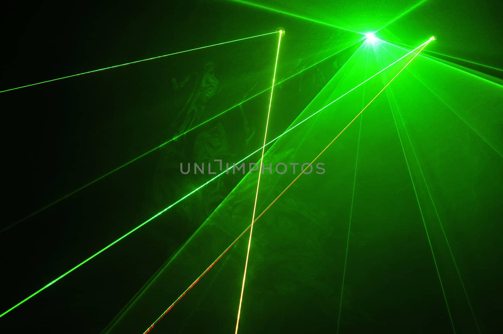 Colour lasers in smoke on a black background.