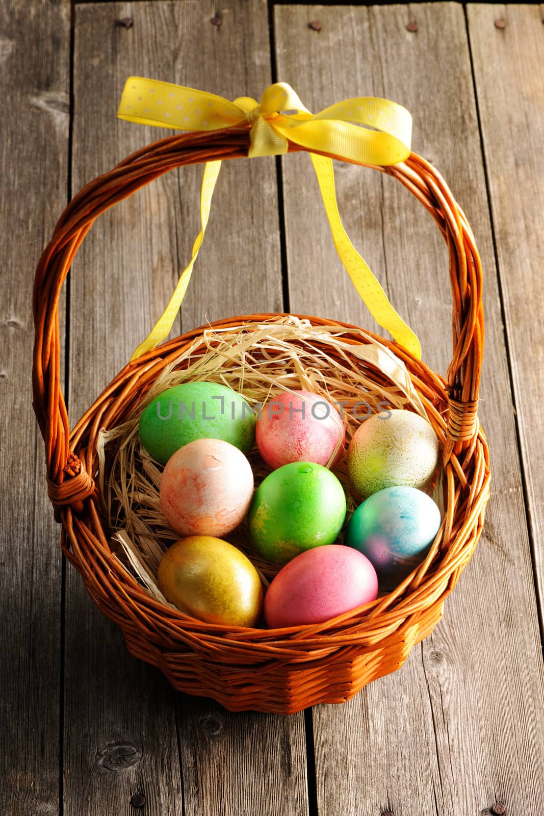 Colored easter eggs in basket by haveseen