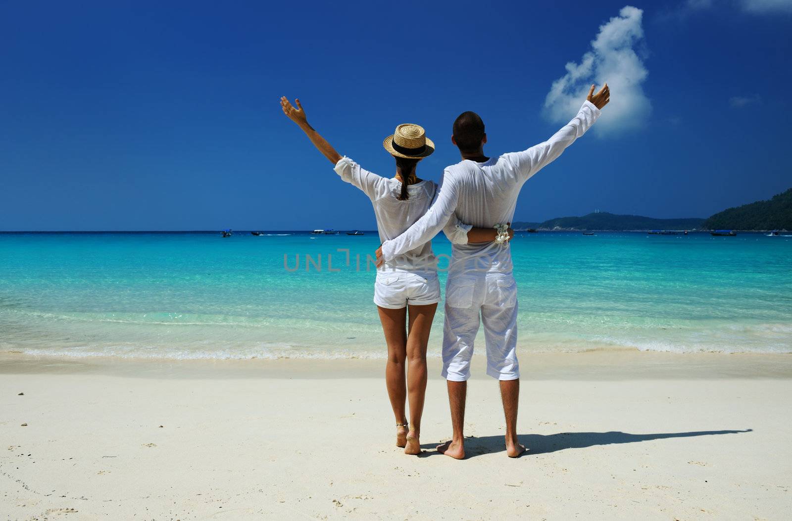 Couple in white on a tropical beach