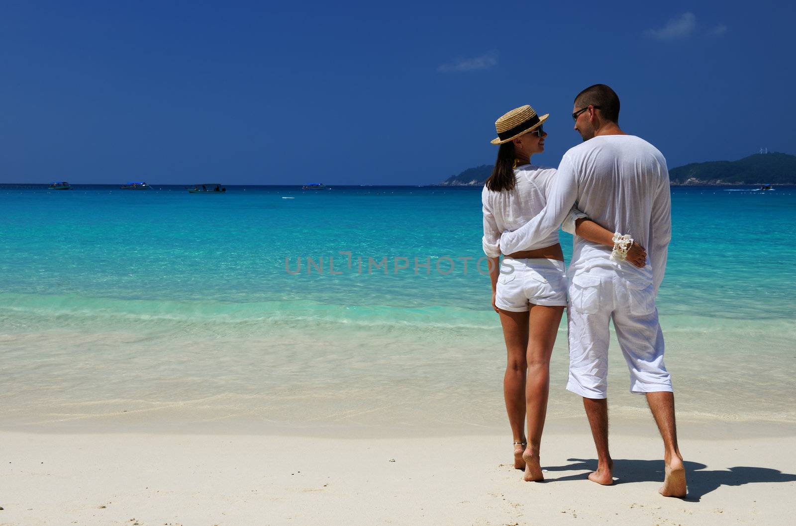 Couple in white on a tropical beach