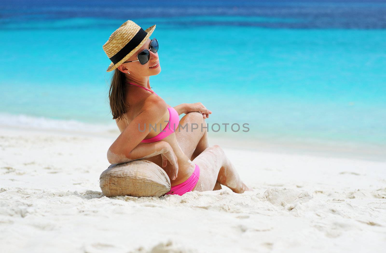 Woman at beach wearing hat