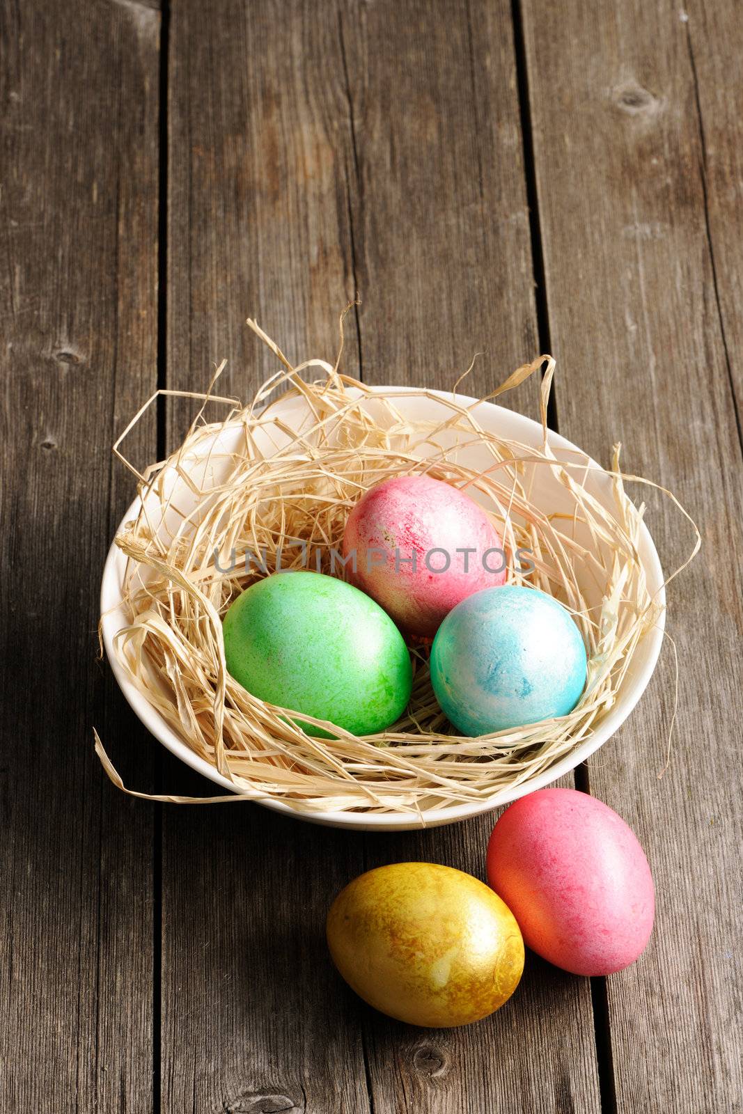 Colored easter eggs in nest by haveseen