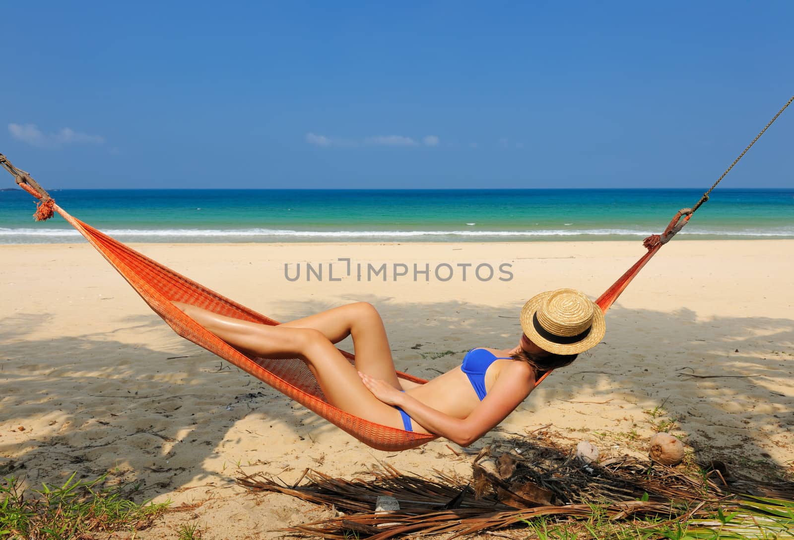 Woman in hammock on tropical beach at Tioman island, Malaysia