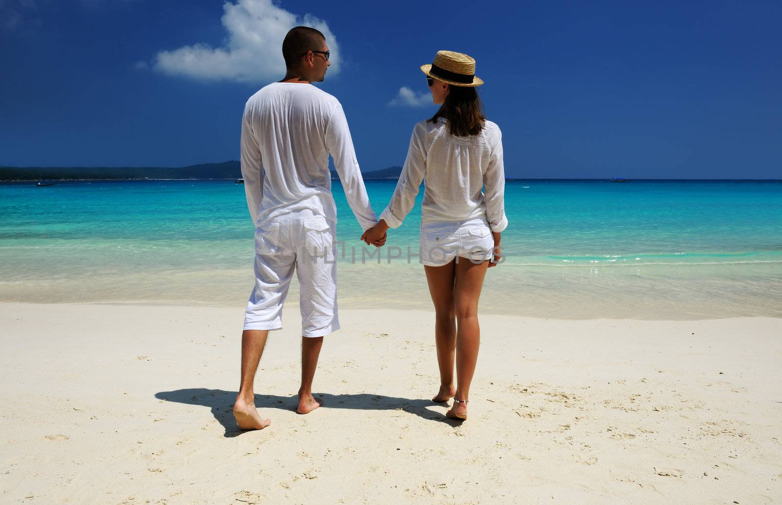 Couple in white on a tropical beach