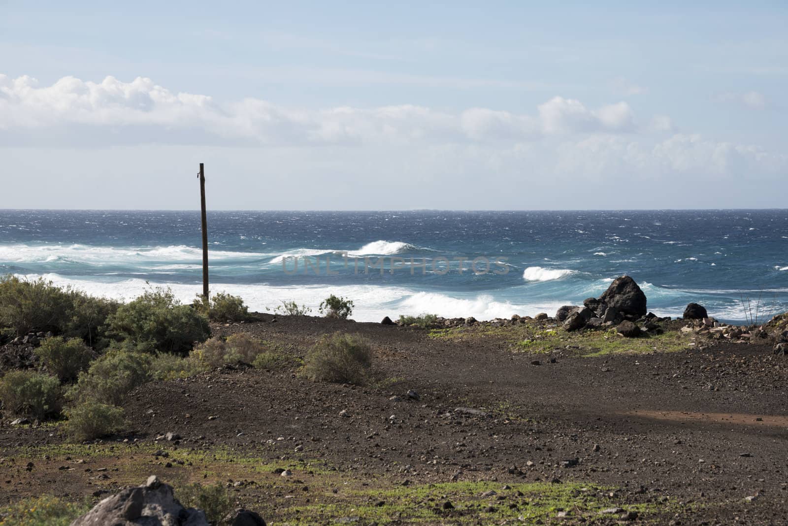 coastline tenerife with dry land and waves on the water