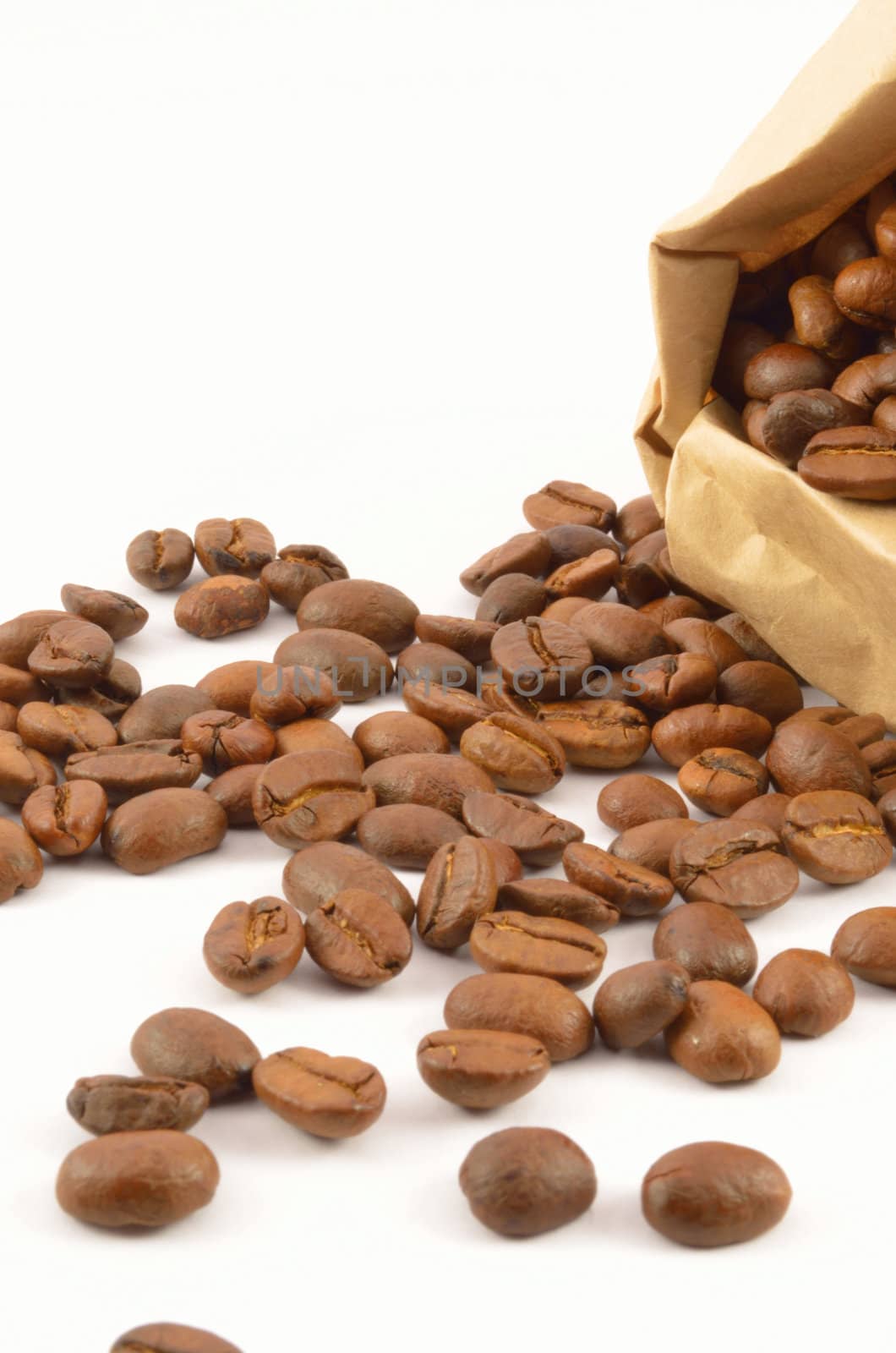 Roasted coffee grains close-up on an isolated white background 