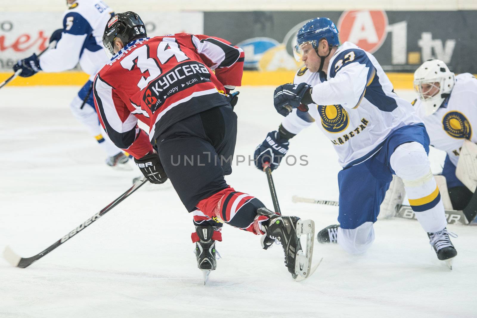 VIENNA - FEB 3: International hockey game between Austria and Kazakhstan. Markus Peintner shoots the puck, but Vitali Kolesnik makes the save on February 3, 2013 at Albert Schultz Halle in Vienna, Austria.