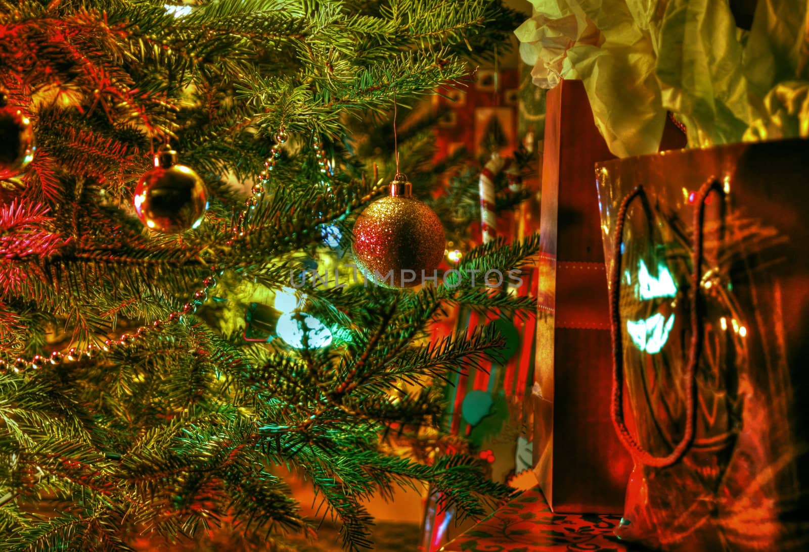 Wraped gifts under a Christmas tree and decorations