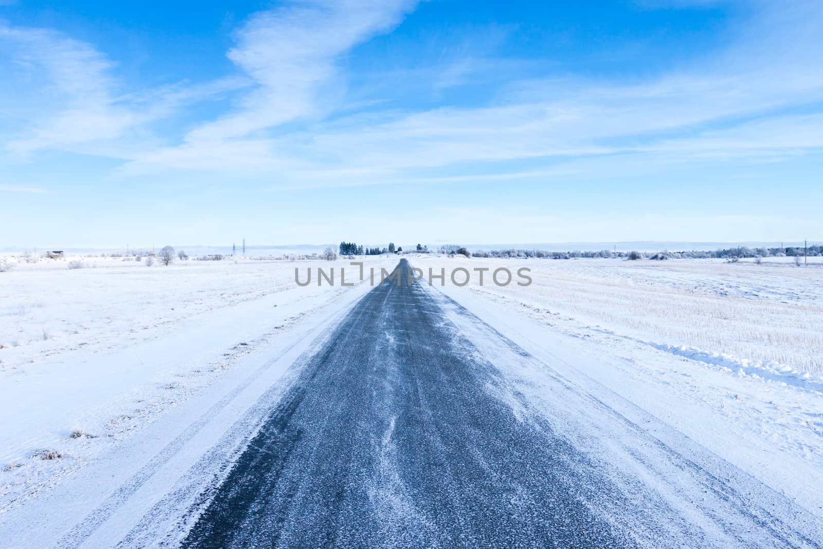 Countryside road through winter field by RTsubin