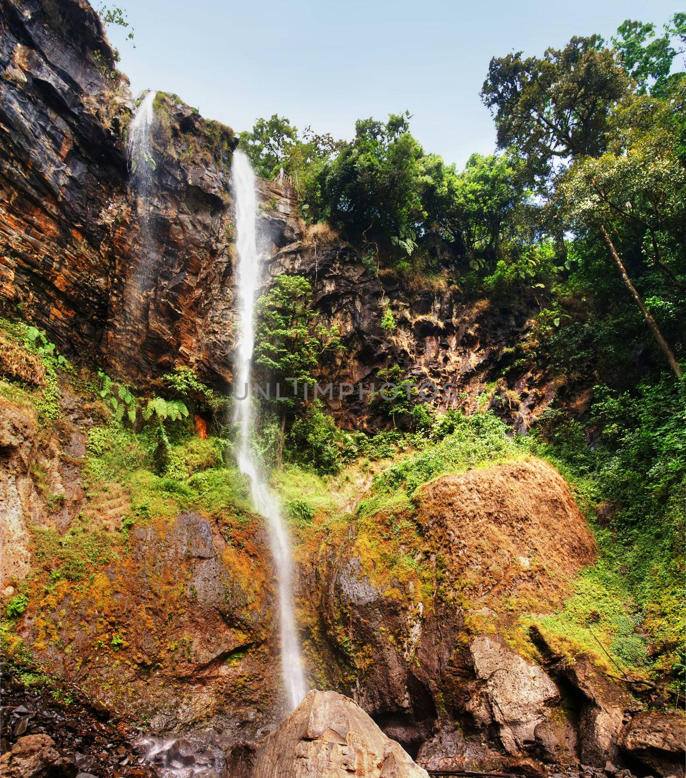XXL Beautiful sacred waterfall with colonial observation deck deep into the thick and lush african tropical forest, great nature background.