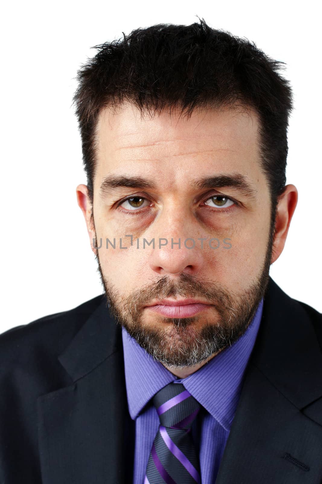 Portrait of middle aged caucasian man with beard, looking sad or angry, could be disgruntled employee or depressed, stressed or overworked boss.