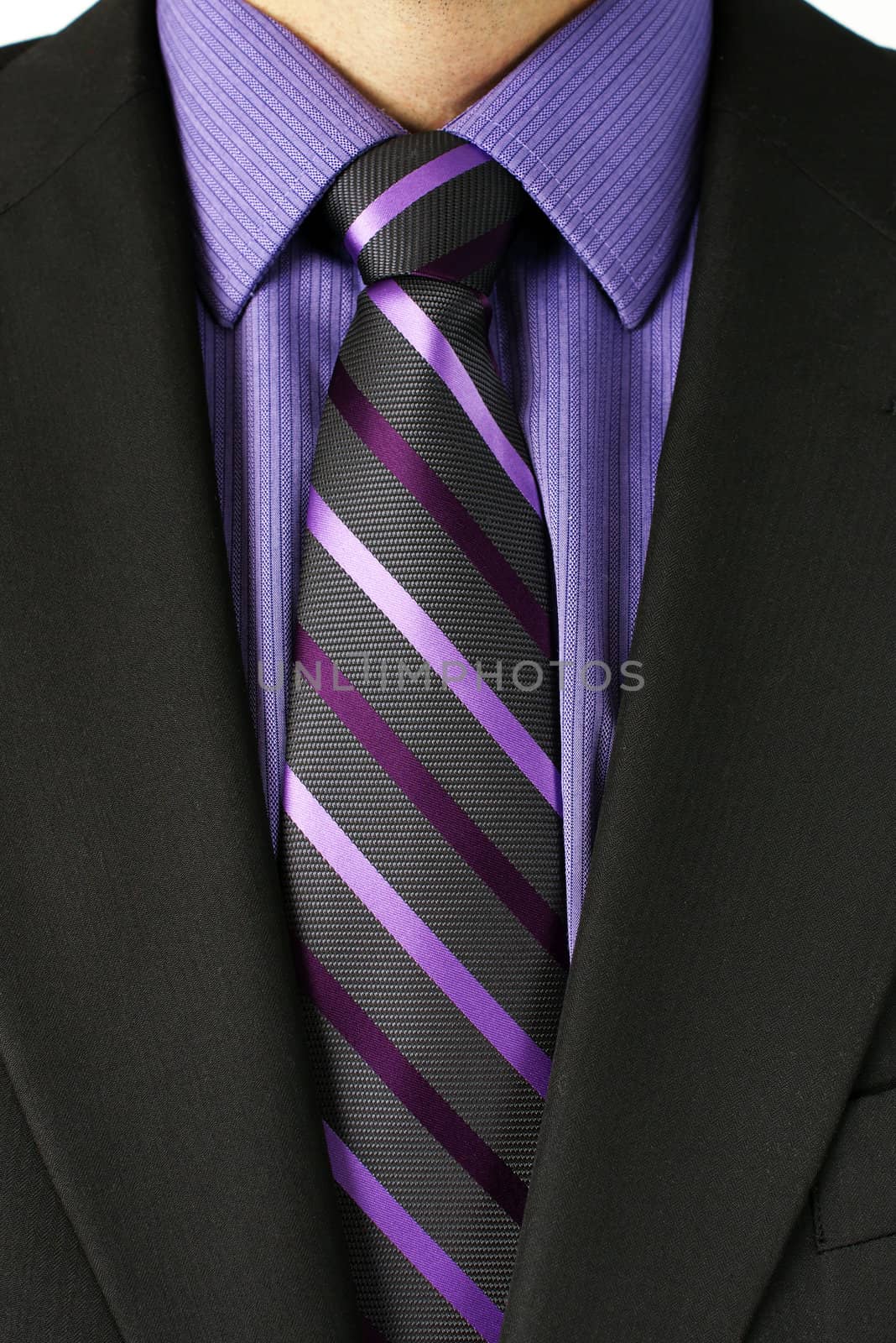 Close up of a businessman torso in dark grey or black suit with purple shirt and striped tie, great details of the textile.