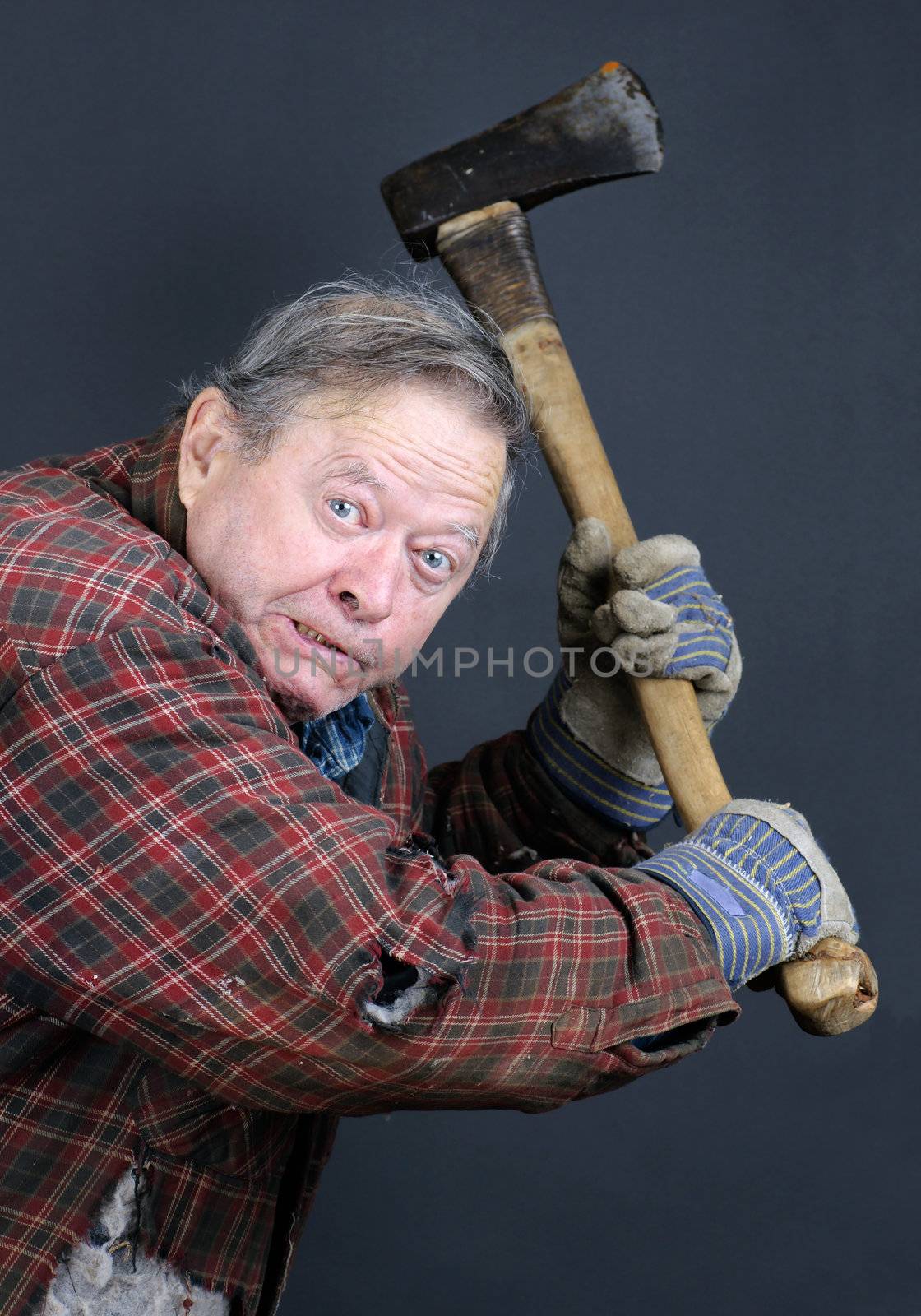 Very scary crazy old man or senior making face and threatening with an axe, great details, can be holloween or other horror scene.