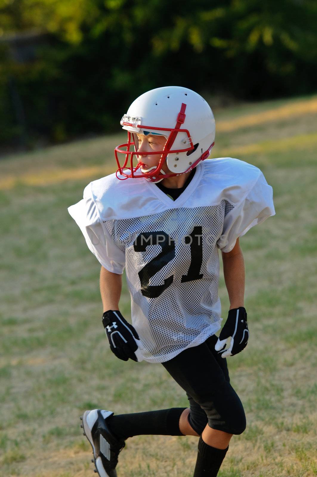 Young football player going out for a pass.