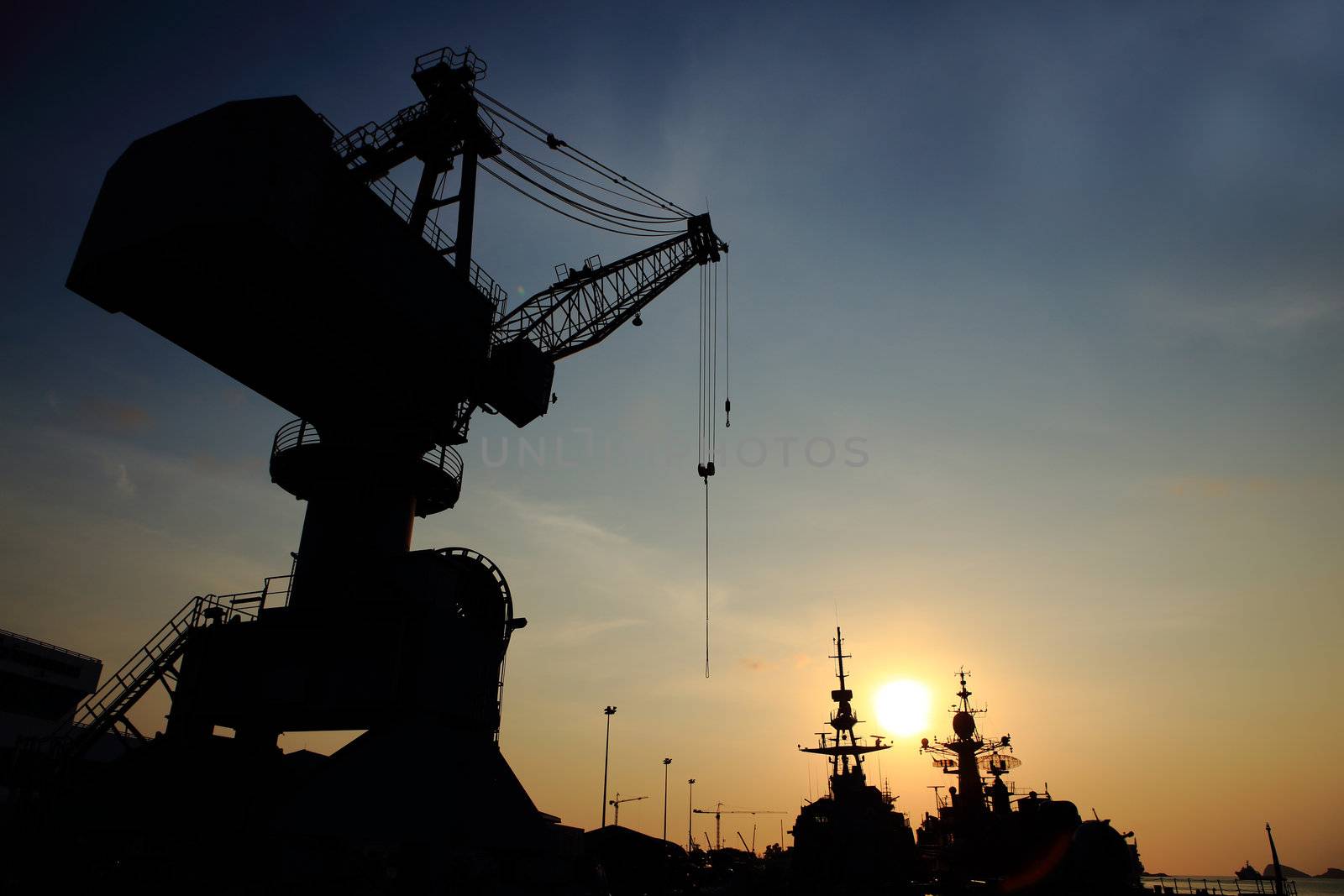 Cranes in dockside at sunset