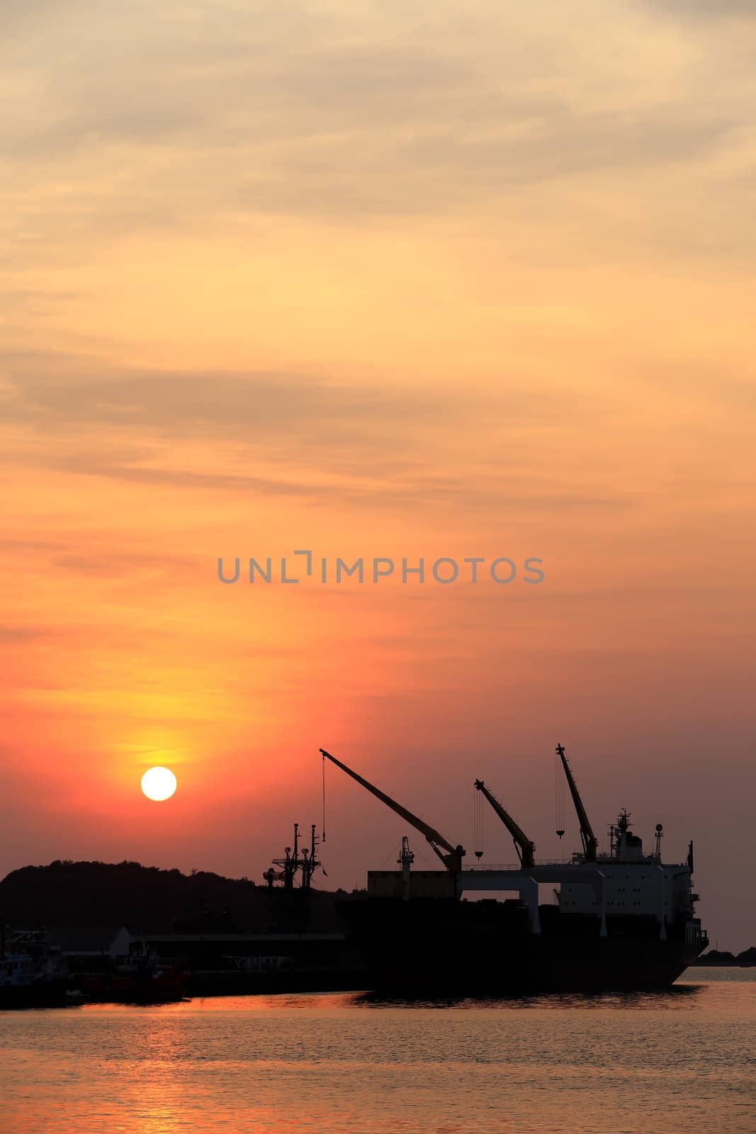 Cargo ship in the harbor at sunset