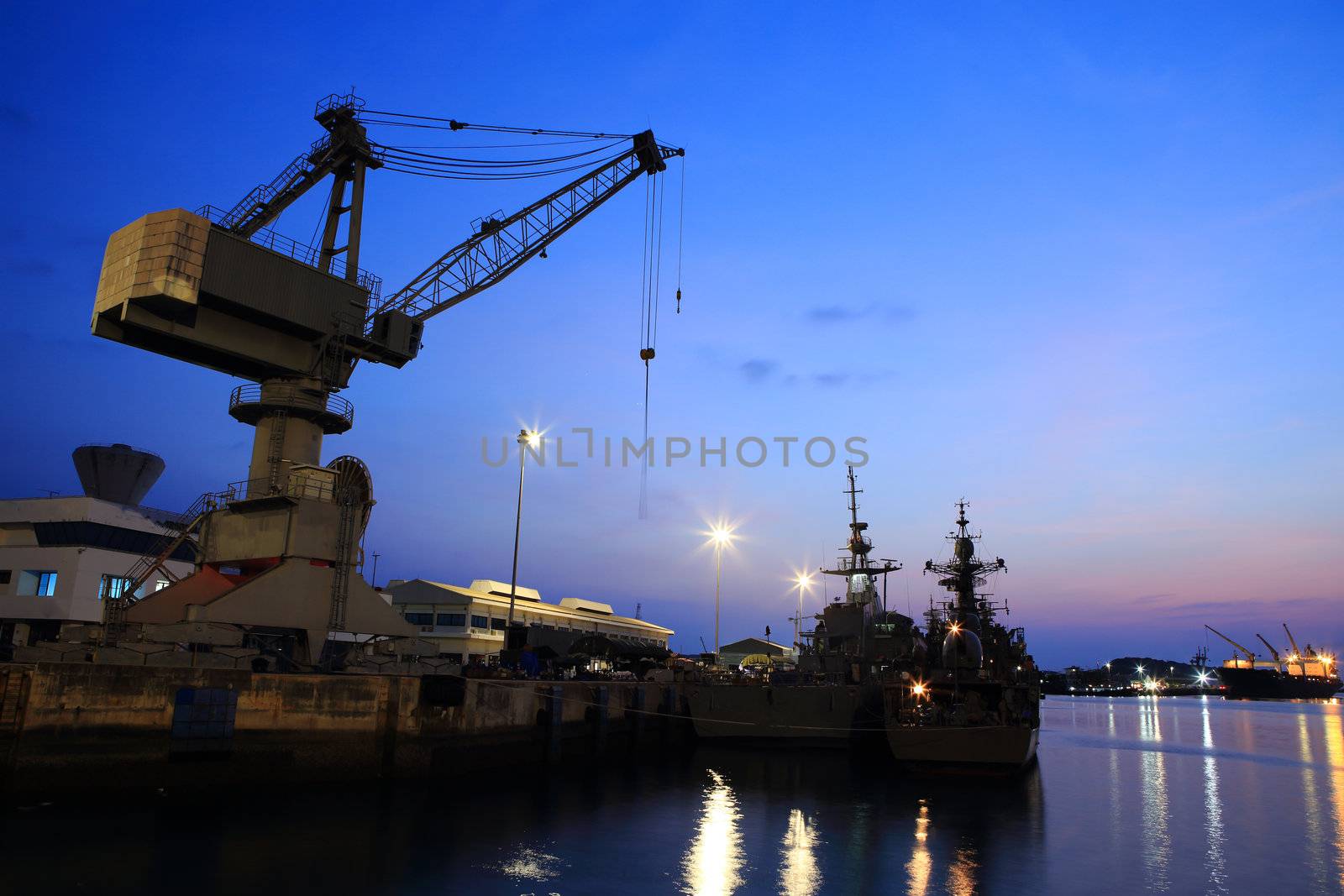 Cranes in dockside at sunset
