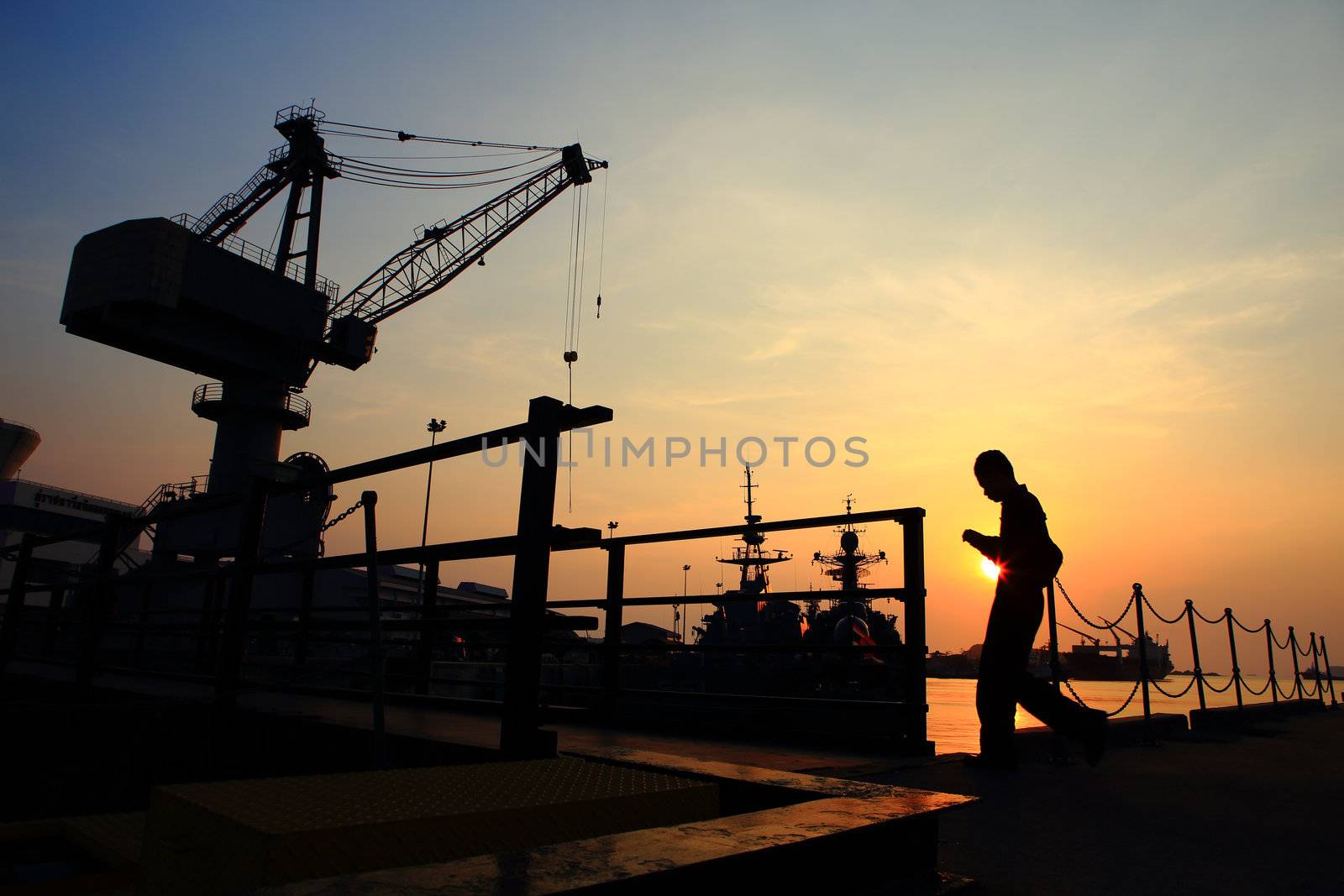 Cranes in dockside at sunset