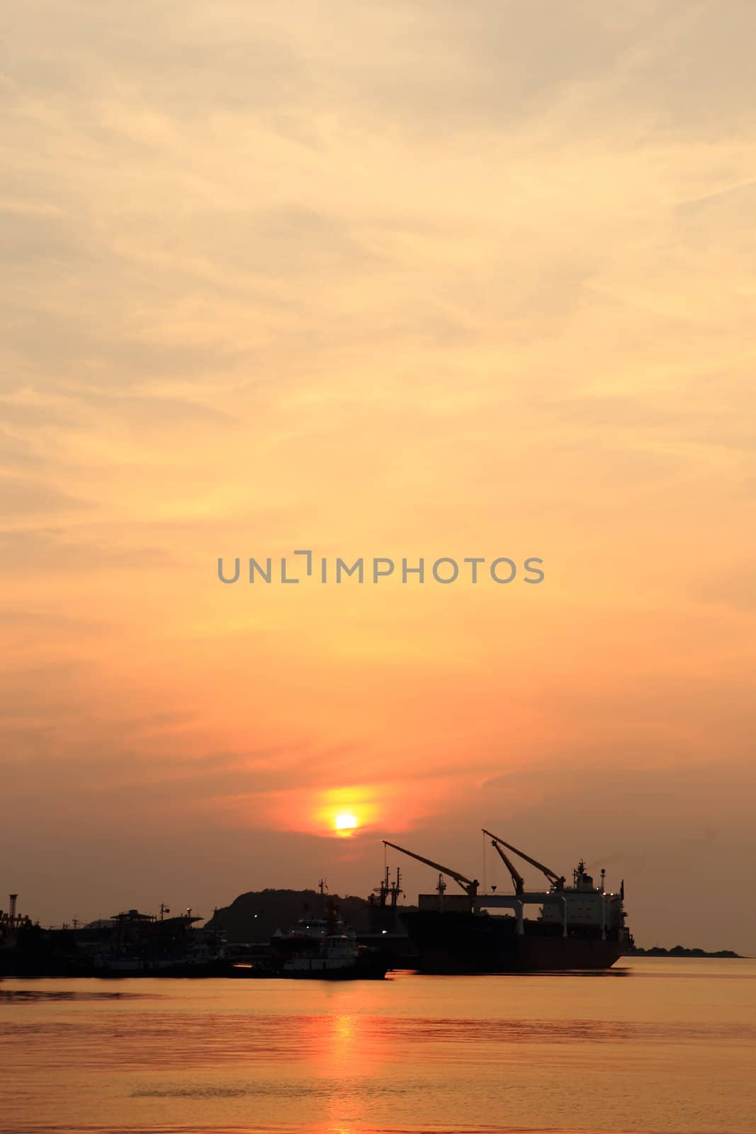 Cargo ship in the harbor at sunset