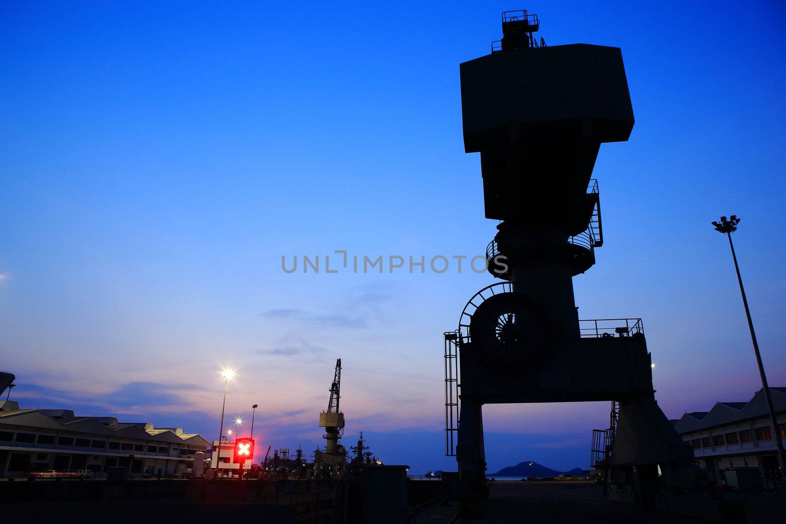 Cranes in dockside at sunset