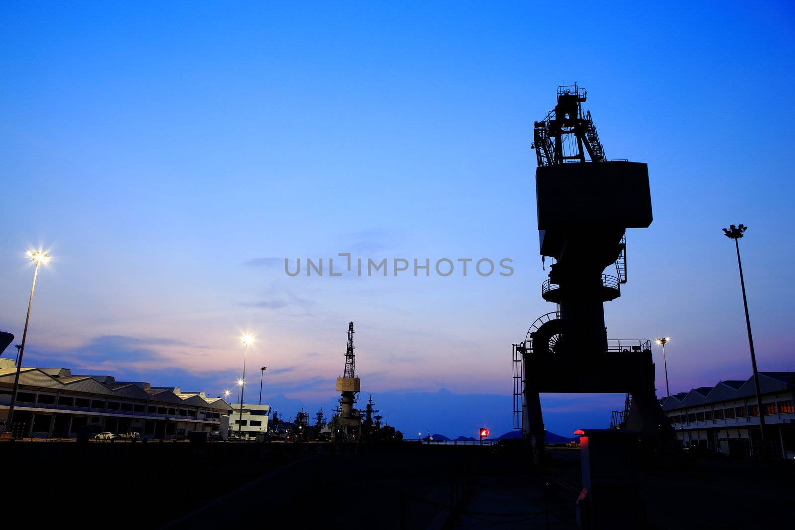 Cranes in dockside at sunset