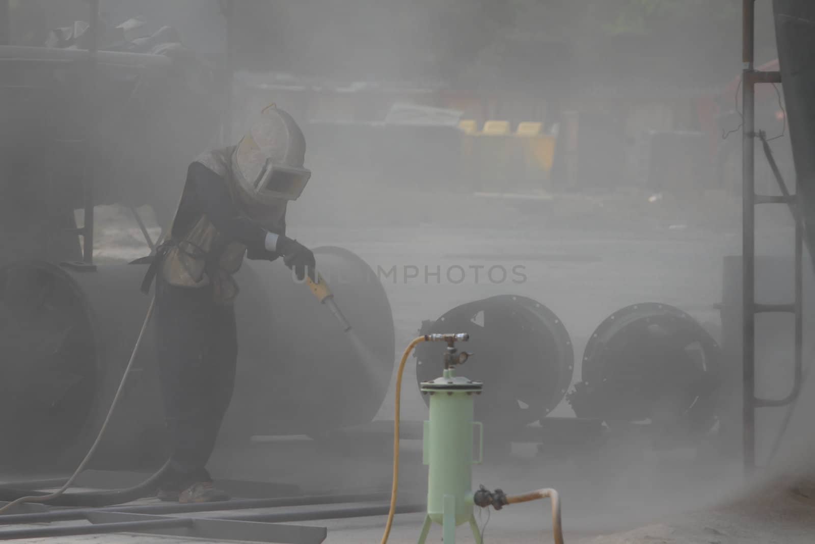 Sandblasting of metal structures at construction site