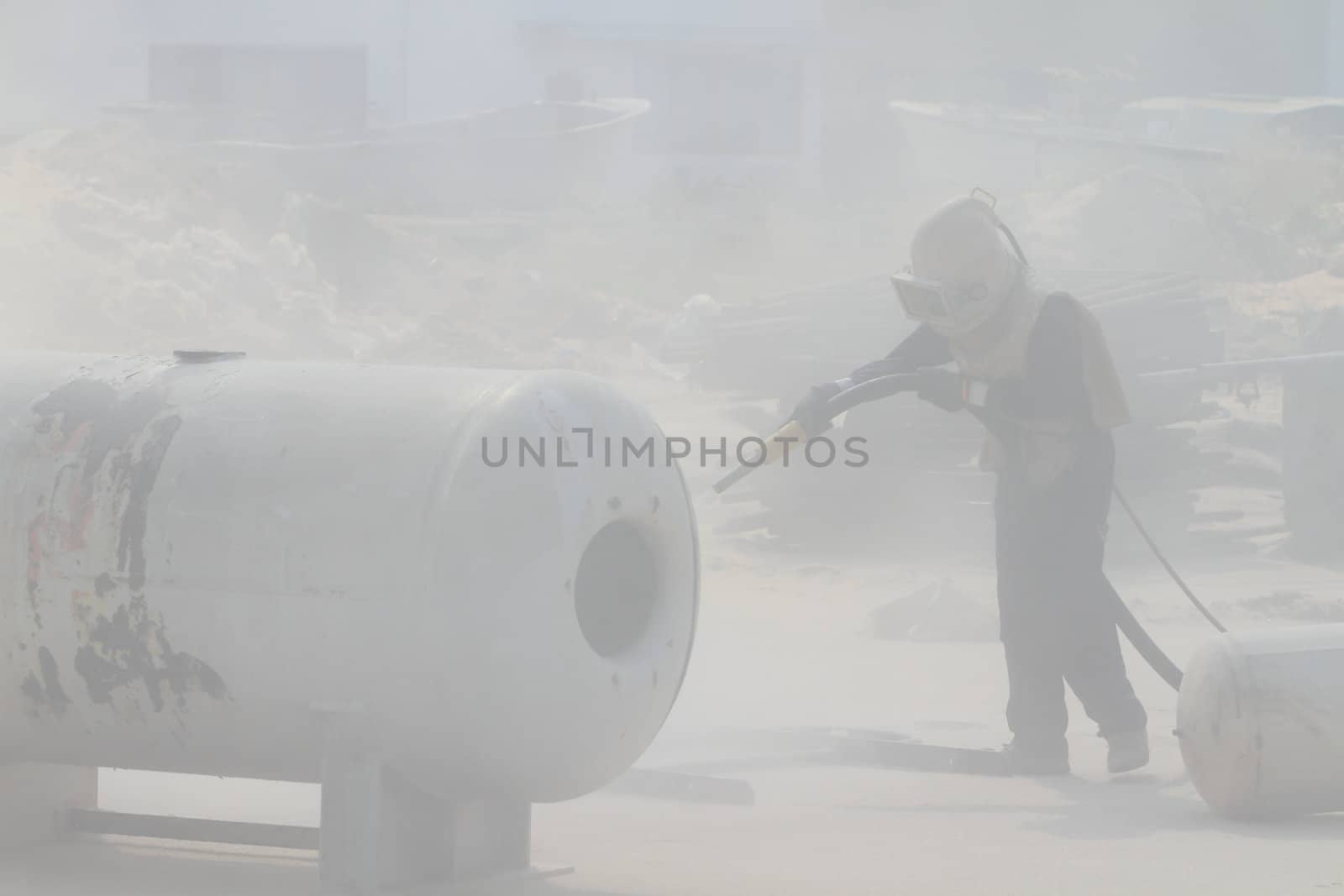 Sandblasting of metal structures at construction site