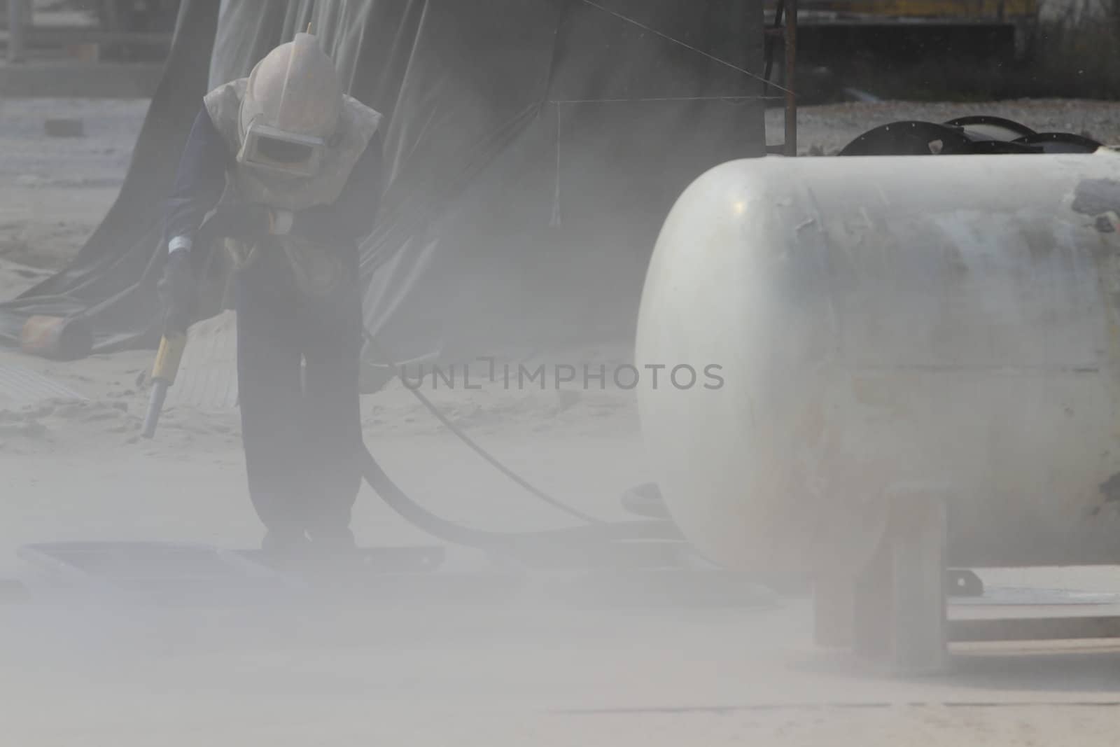 Sandblasting of metal structures at construction site