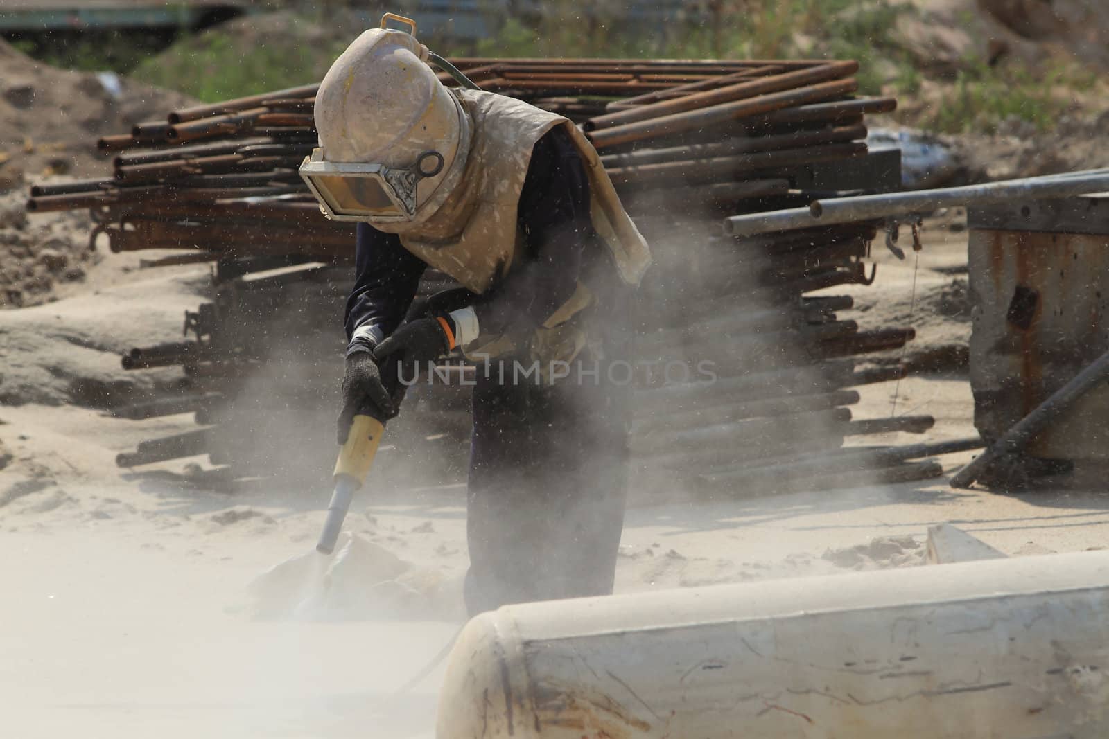 Sandblasting of metal structures at construction site