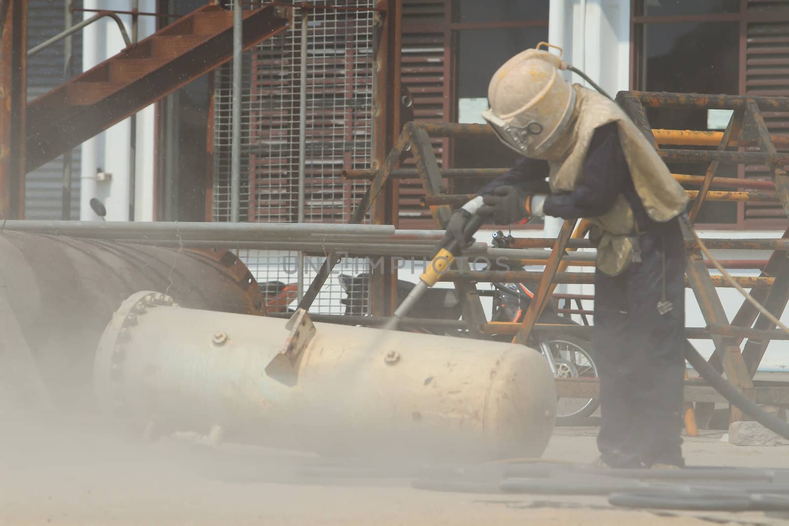 Sandblasting of metal structures at construction site