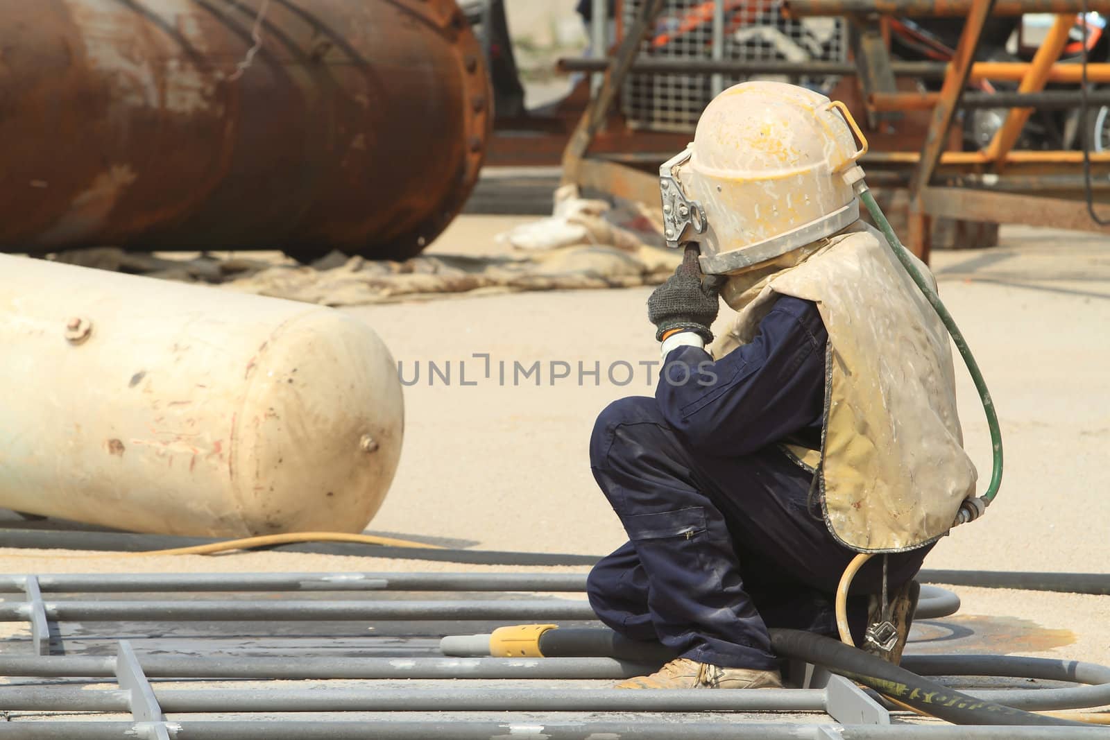 Sandblasting of metal structures at construction site