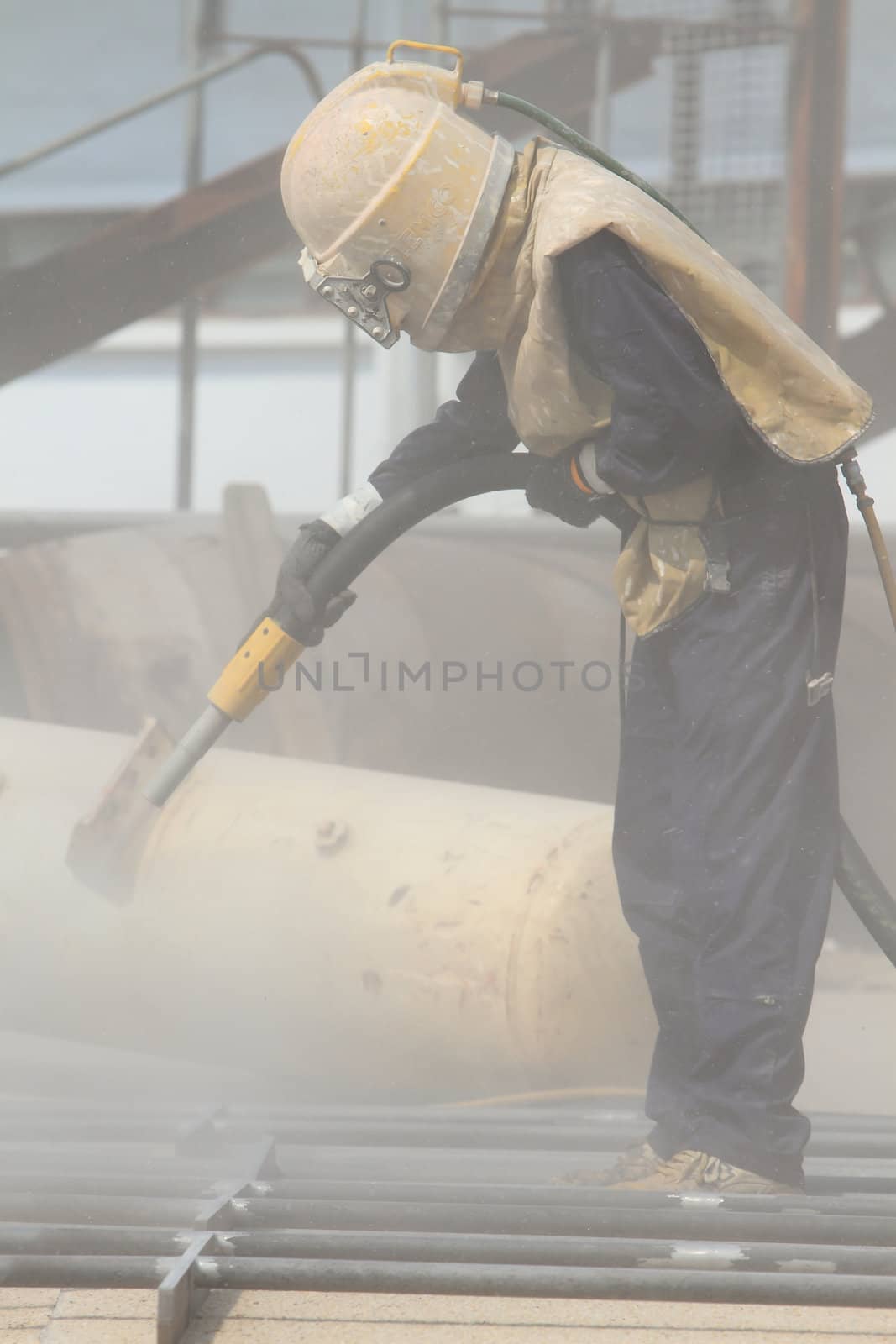 Sandblasting of metal structures at construction site