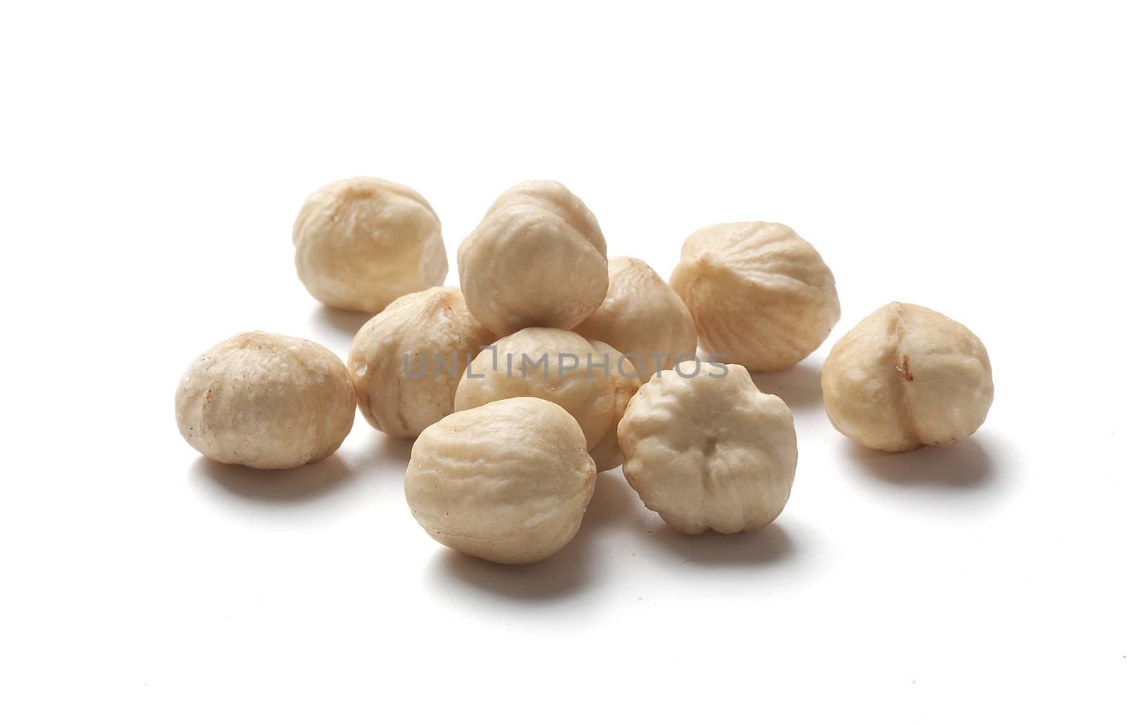 Handful of fried hazelnut on the white background