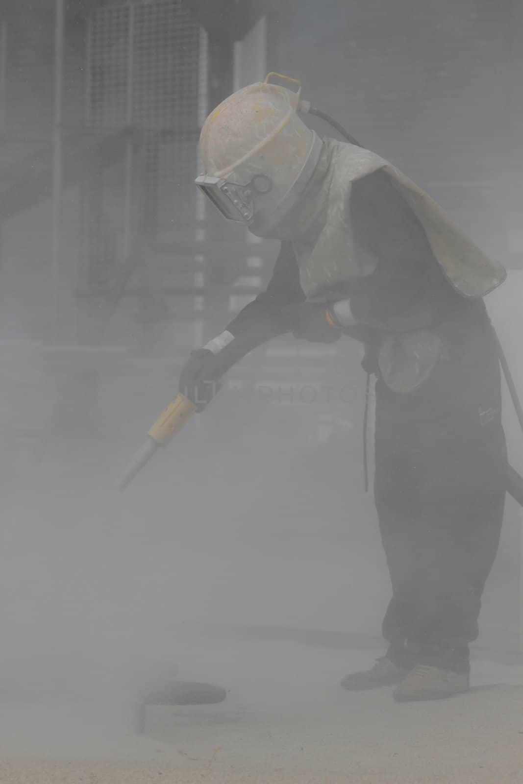 Sandblasting of metal structures at construction site