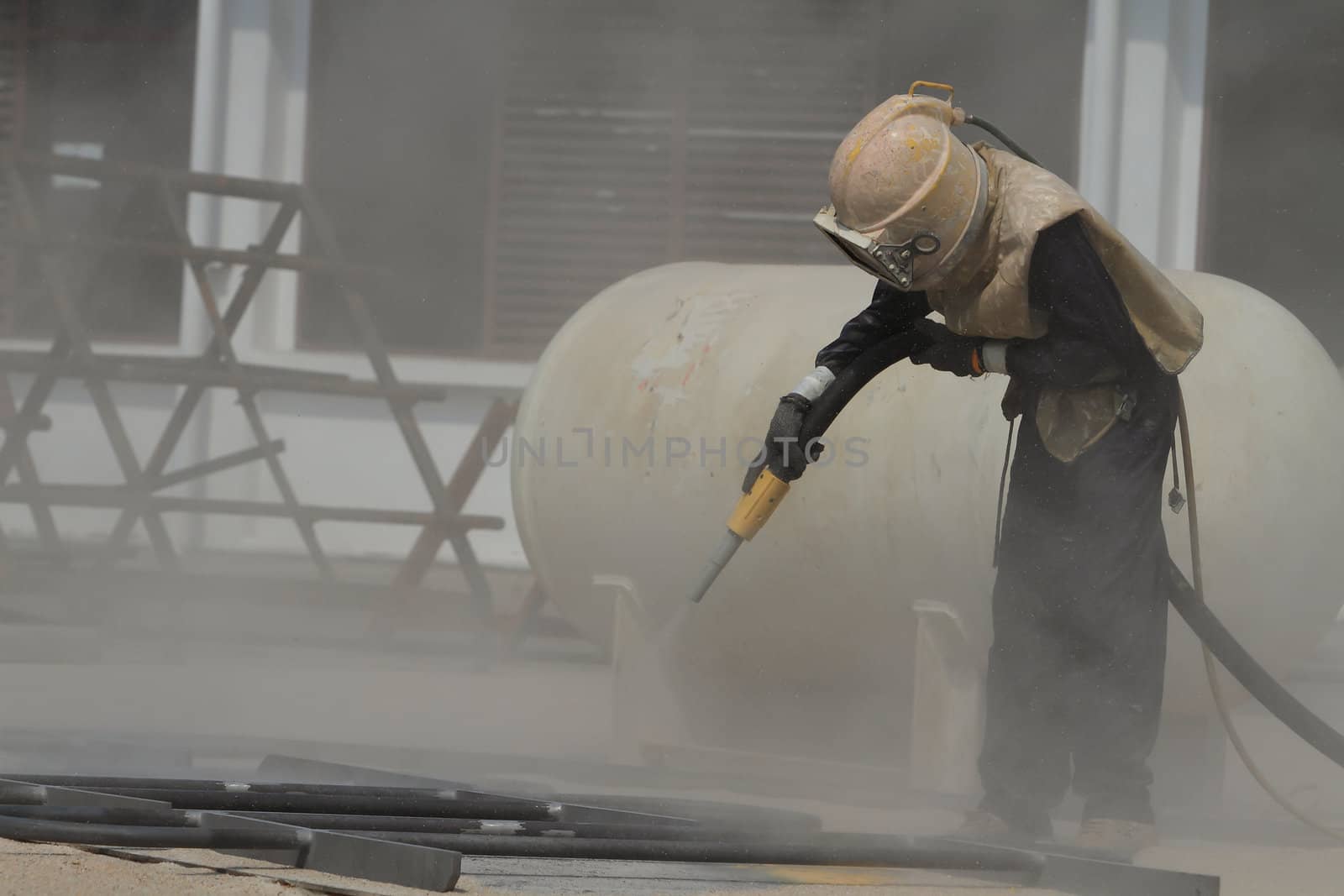 Sandblasting of metal structures at construction site