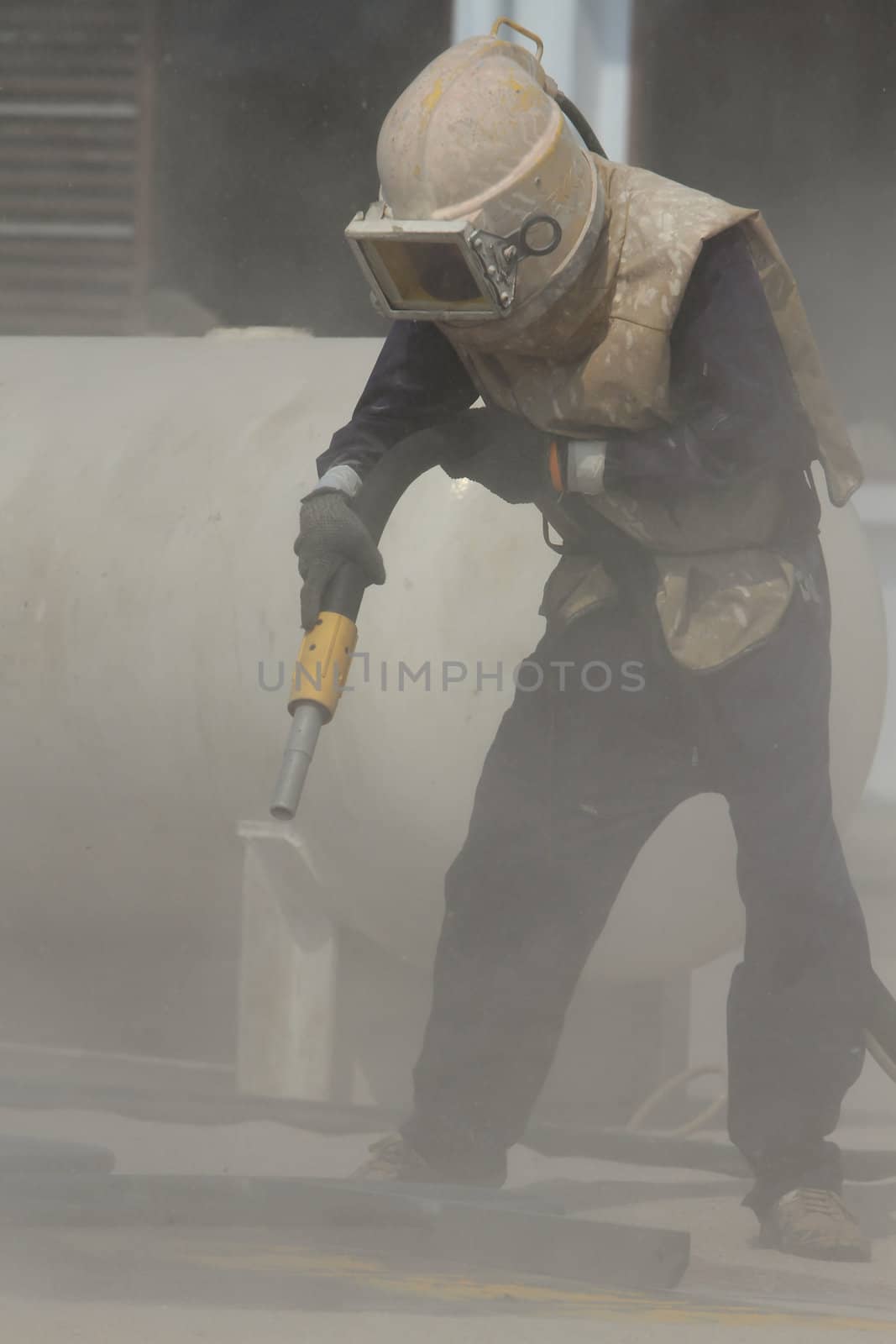 Sandblasting of metal structures at construction site