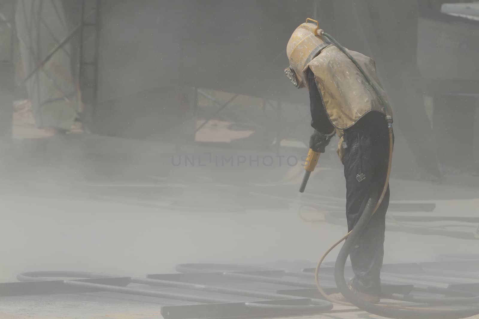Sandblasting of metal structures at construction site