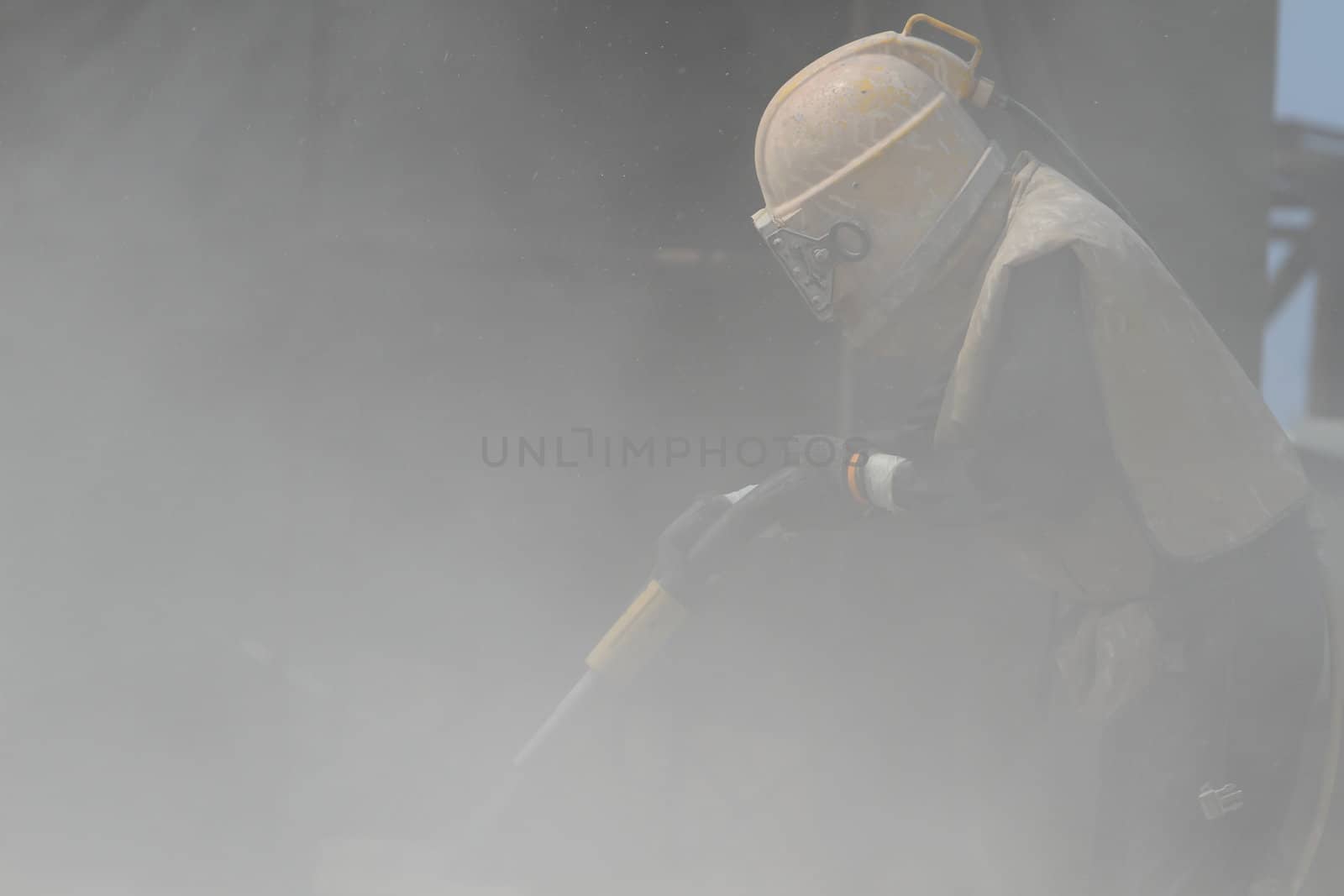 Sandblasting of metal structures at construction site