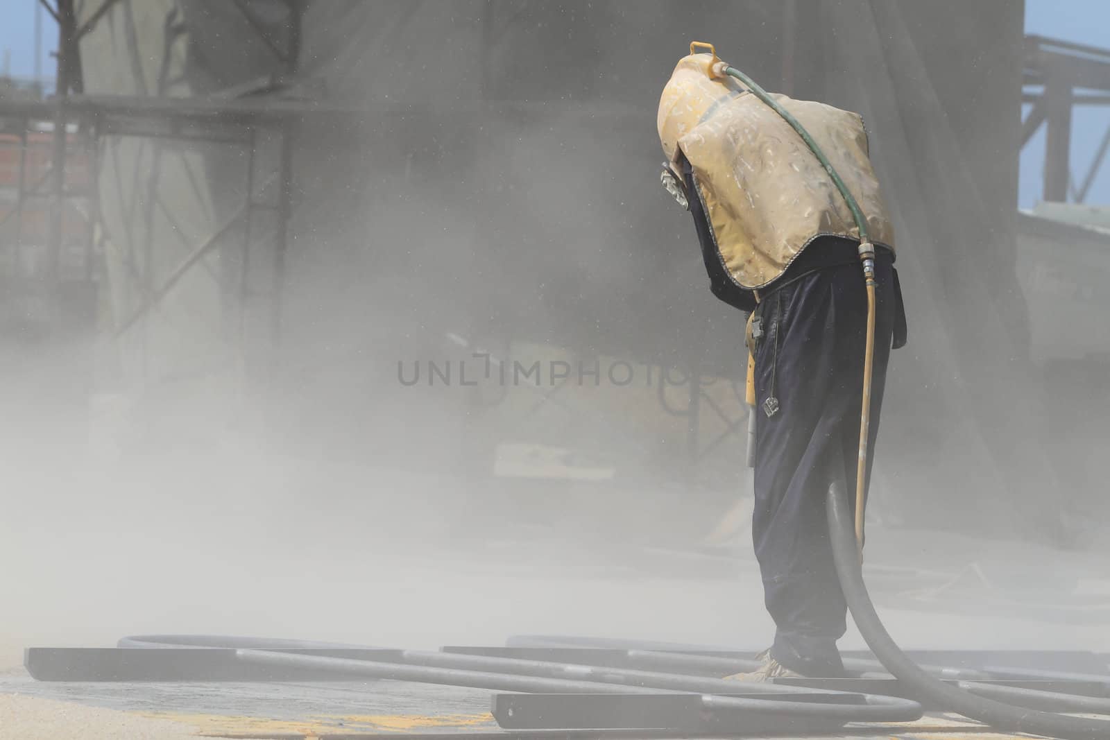 Sandblasting of metal structures at construction site