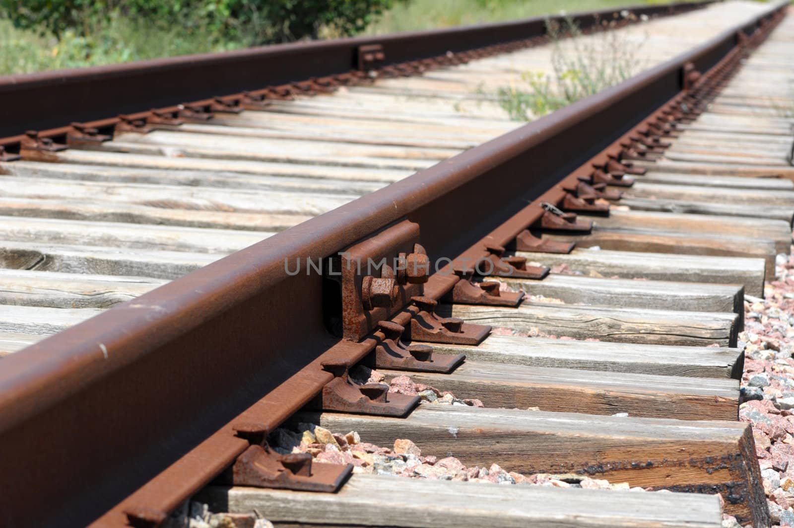 iron rusty train railway detail over dark stones rail way by DNKSTUDIO