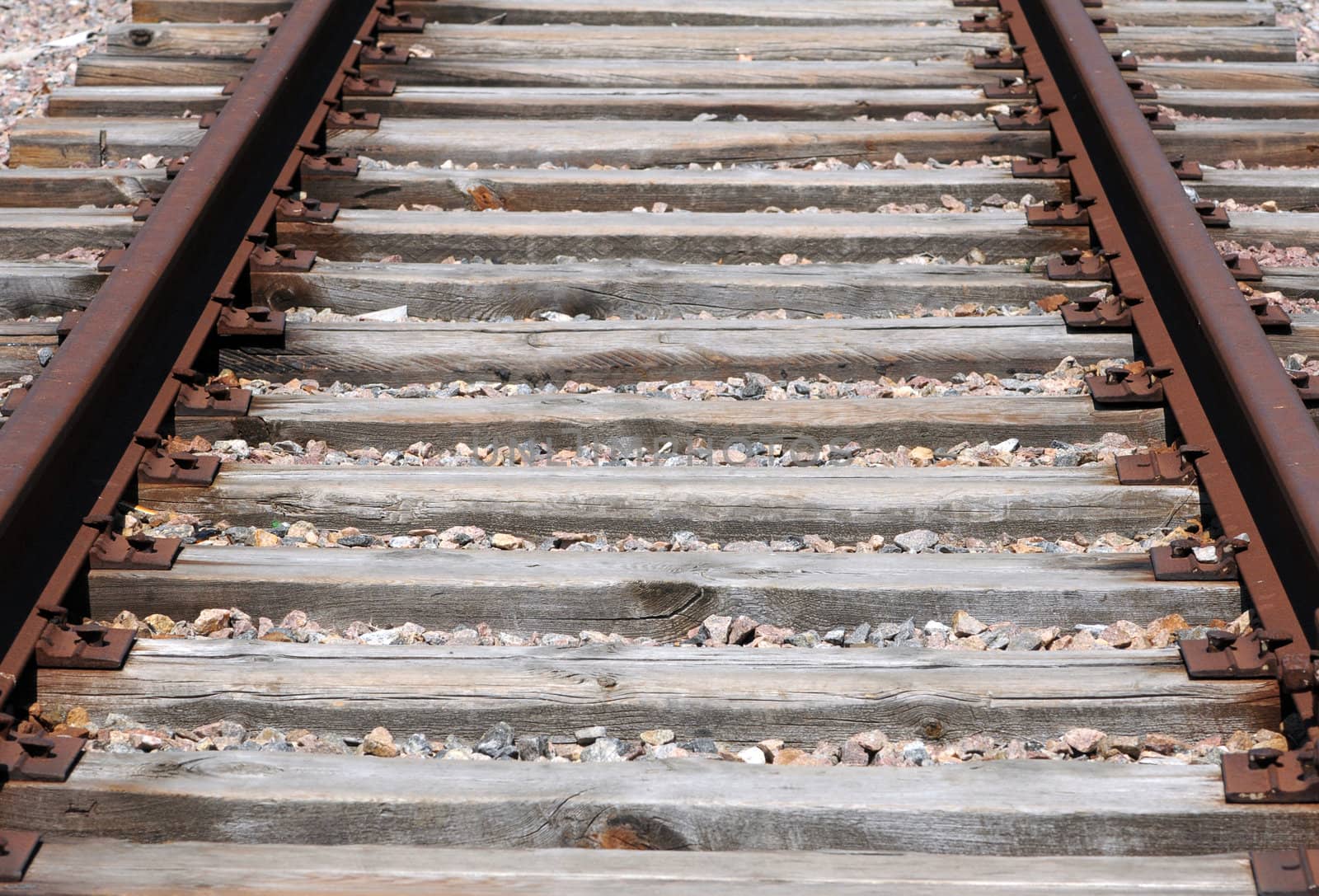 iron rusty train railway detail over dark stones rail way