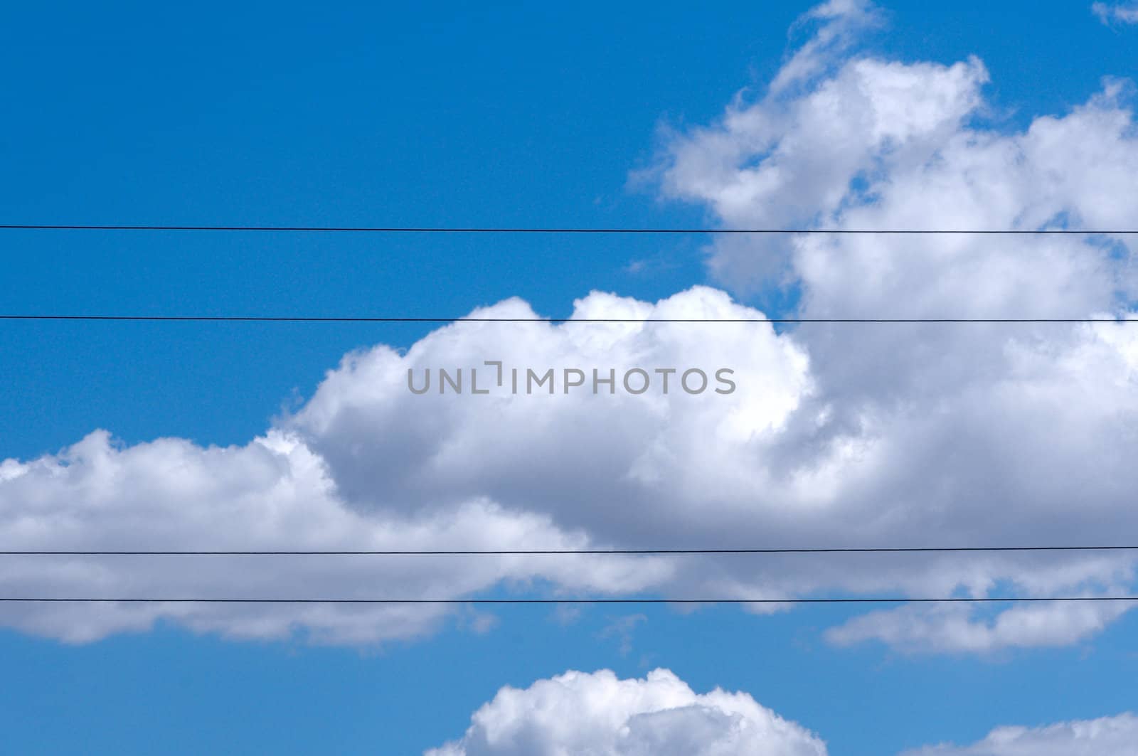 Four of electric wires against clear cloudy blue sky