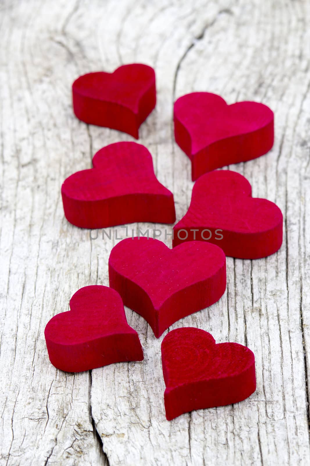 red hearts on old wooden background