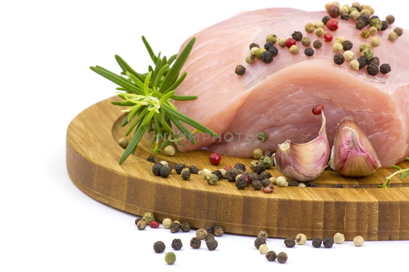 turkey meat on wooden board with various herbs and spices