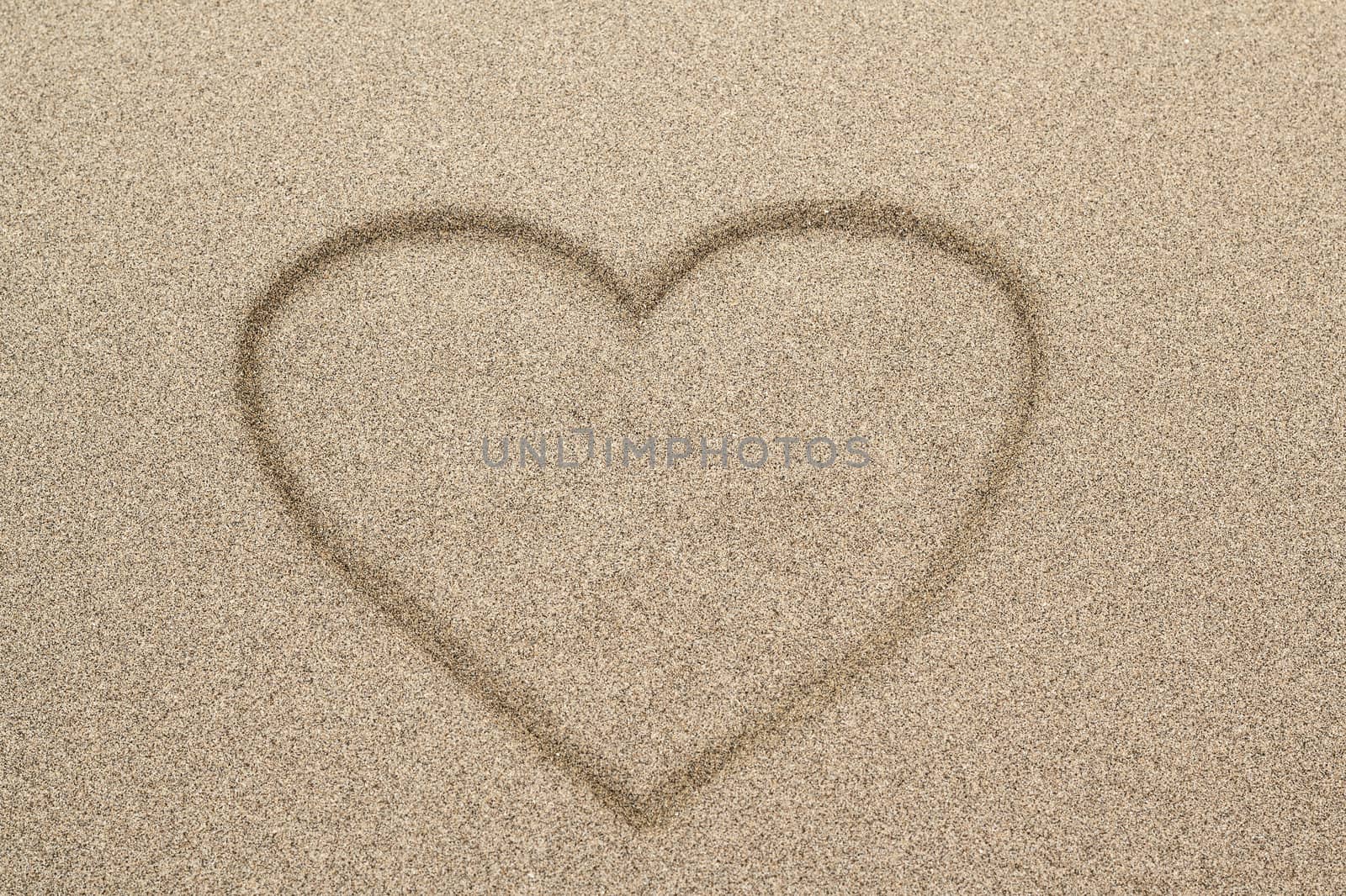Heart shape drawn in sand for natural, symbol,tourism,holiday or conceptual designs 