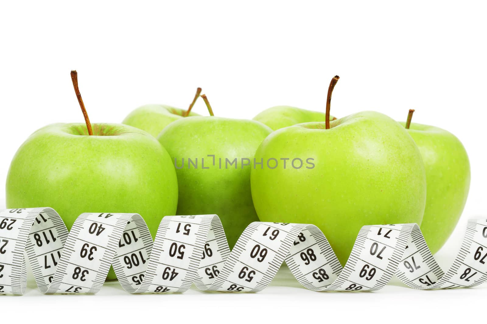 Measuring tape around a green apples as a symbol of diet on white background