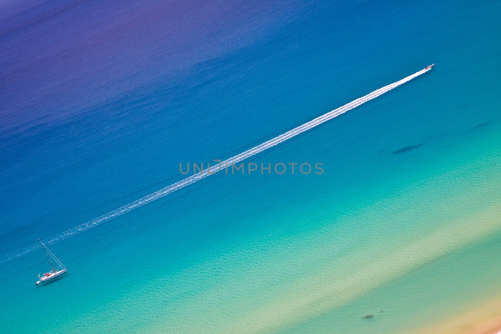 Yacht and motorboat on the background of blue sea