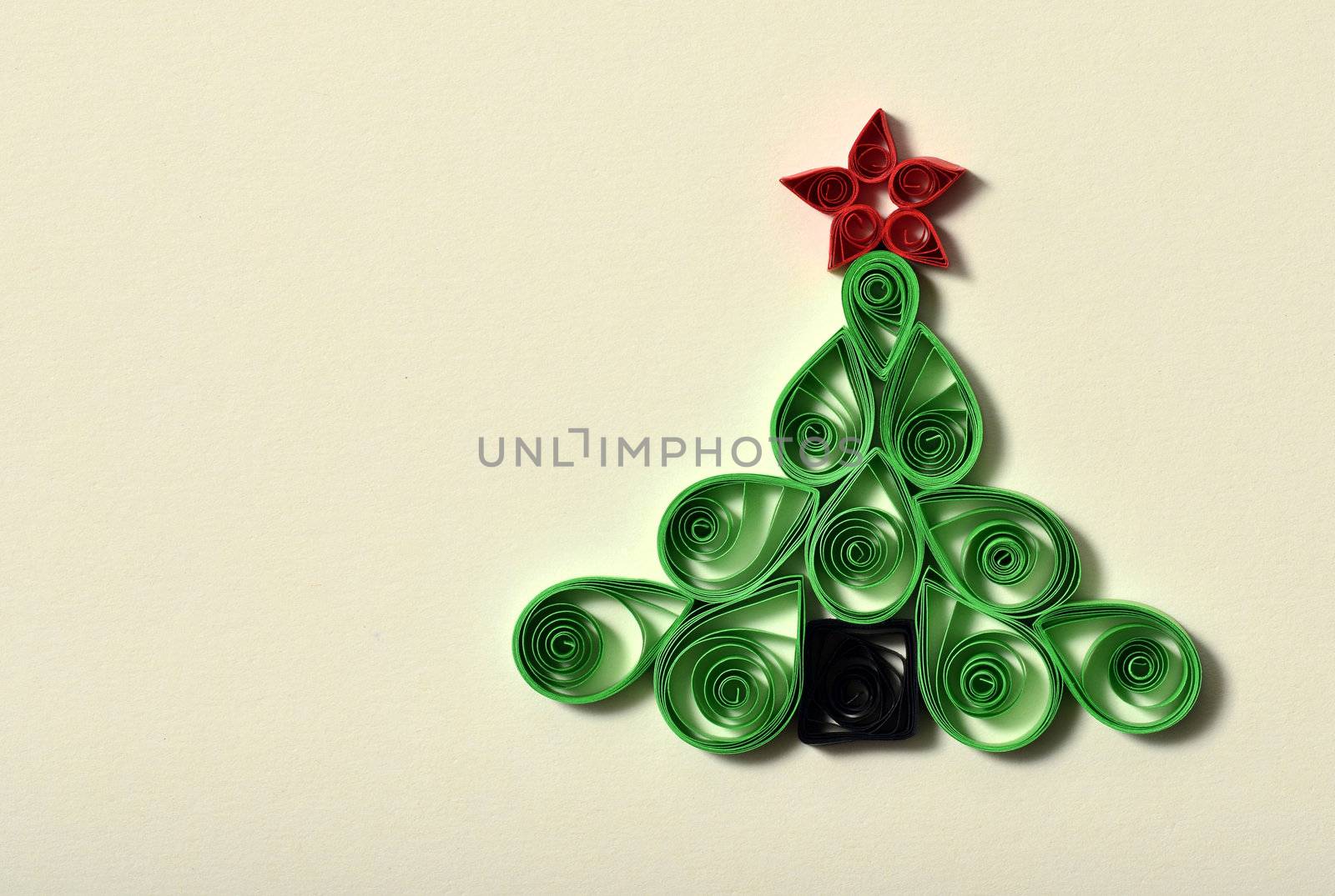 Handmade Christmas tree cut out from paper. Quilling.