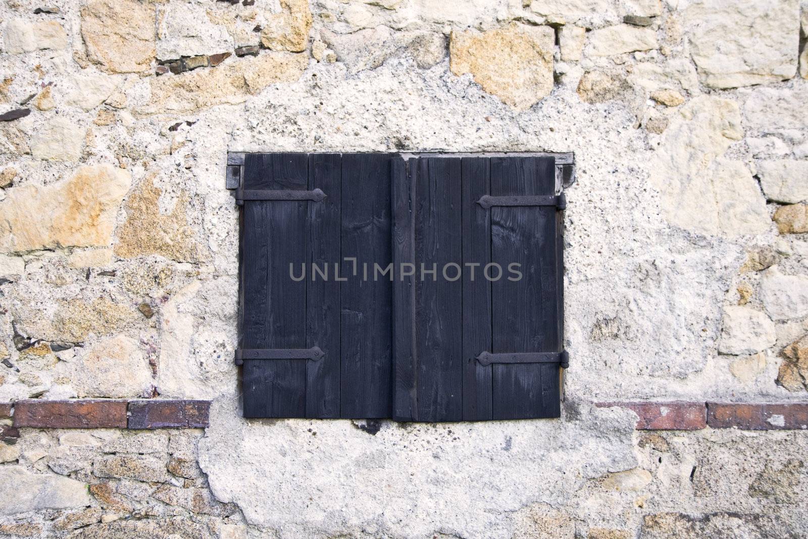 Wooden shutters on the background of the stone walls, architectural detail