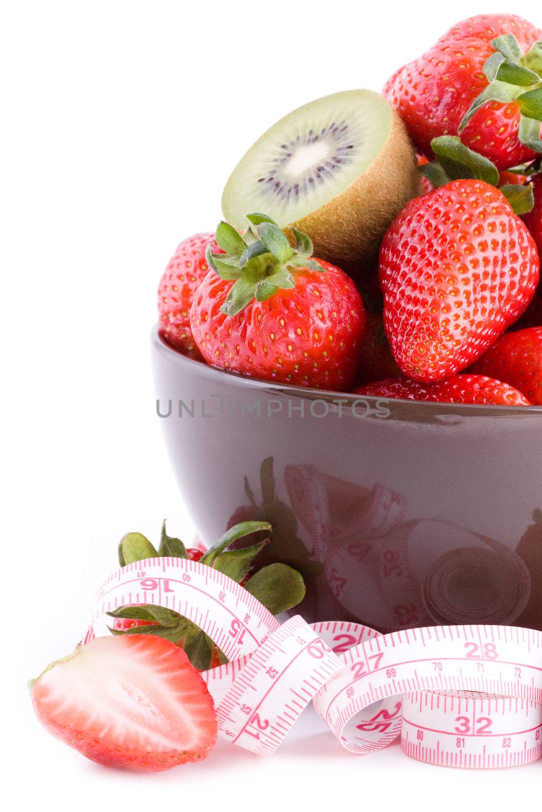 Closeup on fresh strawberries in a bowl with measure tape